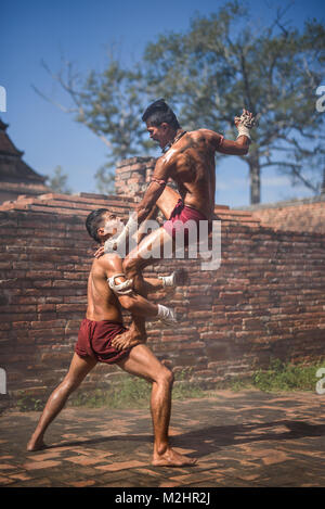 AYUTTHAYA, THAILAND - DECEMBER 17: Two ancient fighter  that known as Muay Thai are fighting in the archaeological site on December 17, 2017 in Ayutth Stock Photo