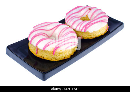 Two fresh round donuts on black plate Stock Photo