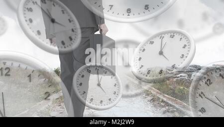 Businessman holding briefcase with surreal clocks time transition Stock Photo