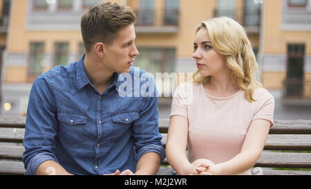 Couple having conflict, looking at each other and talking about problem, crisis, stock video Stock Photo