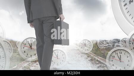 Businessman holding briefcase with surreal clocks time transition Stock Photo