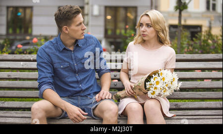 Sad woman feeling guilty, looking at jealous boyfriend, couple having fight, stock video Stock Photo