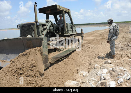 PORT FOURCHON, La. – Louisiana National Guard land bridge project keeps oil out of  inland waters and marshlands on May21, 2010.The land bridge is one of many oil spill projects involving the Louisiana National Guard.  (U.S. Air Force Photo by MSgt. Toby M. Valadie, Louisiana National Guard State Public Affairs Office/Released) Thunder Bay Land Bridge 100521-F-2117V-244 by Louisiana National Guard Stock Photo