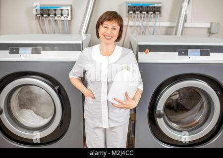 Senior chambermaid in the laundry Stock Photo