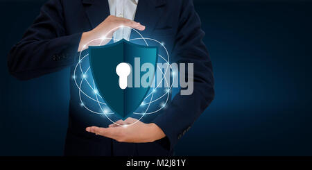 Businessmen shake hands to protect information in cyberspace. Businessman holding shield protect icon protection network security computer and safe yo Stock Photo