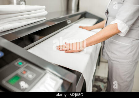 Working with professional ironing machine Stock Photo