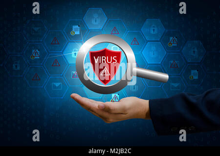 Protect the world cyber businessman computer Protective shield virus red Exclamation Warning Caution Computer in dark with word virus Stock Photo