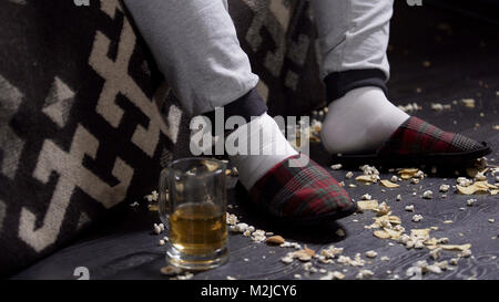 Messy floor with food leftovers, closeup of lazy jobless bachelor man slippers, stock footage Stock Photo