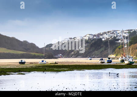 Sailing craft boats yachts moored at low tide on the Gannel River in Newquay Cornwall. Stock Photo