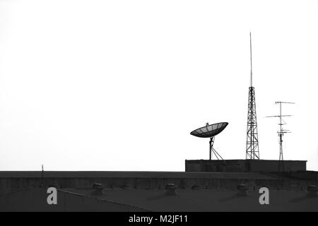 Satellite and antenna  on the top of factory Stock Photo