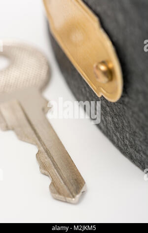 Small padlock on plain background. For concept of data security, email security, secure payment concept, login security, lock her up, Covid lockdown. Stock Photo
