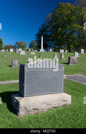 Vertical shot of a blank tombstone in a cemetery. Stock Photo