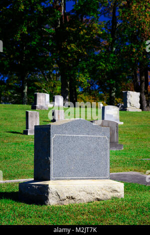 Vertical shot of a blank tombstone in a cemetery. Stock Photo