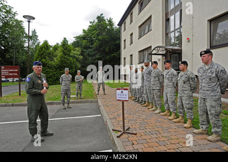 U.S. Air Force Gen. Roger A. Brady, U.S. Air Forces in Europe commander, visits the staff of the Deployment Transition Center, Detachment 1, 86th Mission Support Group, Ramstein Air Base, Germany, July 27, 2010. General Brady visited to review and discuss USAFE execution of the new Airmen Resiliency Program aimed at Airmen returning from the area of responsibility who are in career fields that experience frequent ‘outside-the-wire’ missions. The DTC provides deployment returnees an opportunity to decompress and reintegrate into home and work life with a resilience building, strength-based appr Stock Photo