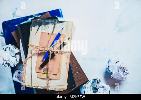 Stack of drafts, pencil boxes and papers with two pencils. Editor or writer workplace. Stock Photo