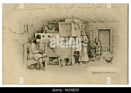 Old German postcard: 'Russian country house' Family next to a typical brick stove inside a wooden hut. The first world war of 1914-1918 Stock Photo