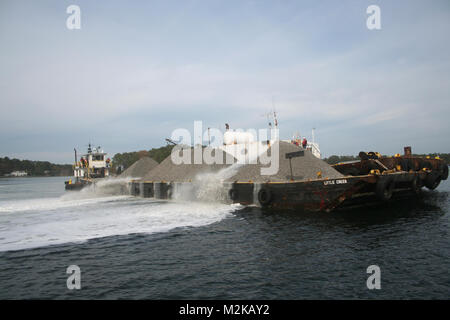 Contractors working for the U.S. Army Corps of Engineers, Norfolk District, use high-pressure water cannons to spread fossilized oyster shell in the Lynnhaven River in Virginia Beach, Va., in an effort to build medium relief oyster reefs for an ongoing oyster restoration project. Lynnhaven River Oyster Restoration (071130-A-5177B-001) by norfolkdistrict Stock Photo