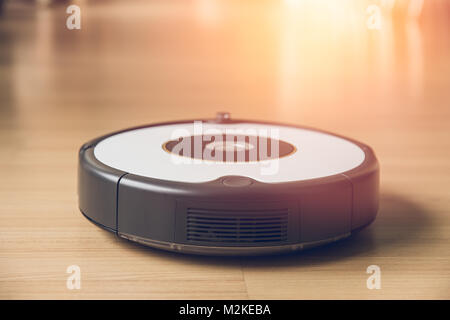 robot vacuum clean wood floor easy home cleaning technology every morning concept Stock Photo
