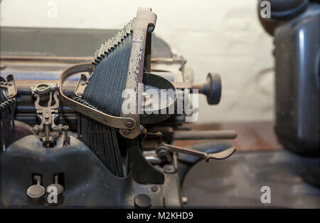 Antique typewriter in vintage and grunge looks on a wooden table.Closeup Stock Photo