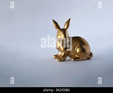 Easter golden bunny isolated on green close up Stock Photo