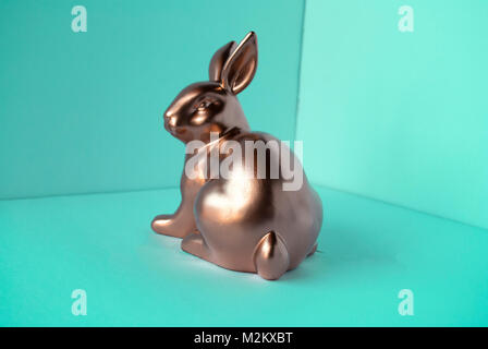 Golden rabbit in emerald room close-up isolated. Easter decoration Stock Photo