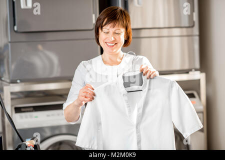 Senior washwoman in the laundry Stock Photo