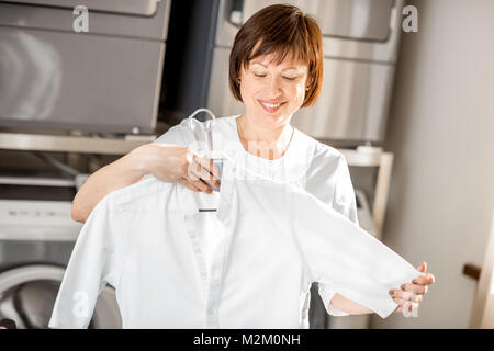 Senior washwoman in the laundry Stock Photo