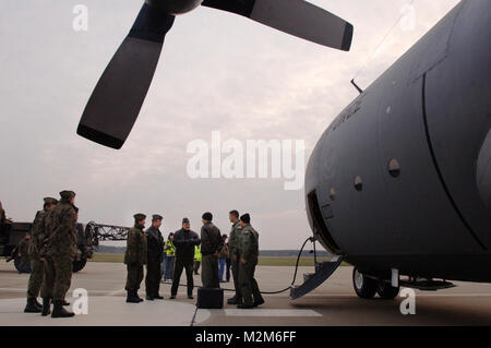 After flying a US Air Force H-model C-130 Hercules to its final destination of Powidz Air Base, Poland, aircraft commander, Captain Tyler Robertson, navigator, Capt Ryan Donohoe and flight engineer, Staff Sgt. Eric Kleser are greeted by Polish Air Force's 33rd Air Base Commander, Brig. General Tadeusz Mikutel (4th from R) and 14th Air Transport Squadron Commander, Lt Col Mieczyslaw Gaudyn (5th from R). The aircraft and crew, from Ramstein Air Base, Germany's 37th Airlift Squadron, are delivering the second US Air Force C-130H Hercules to the country of Poland as part of a program for building  Stock Photo