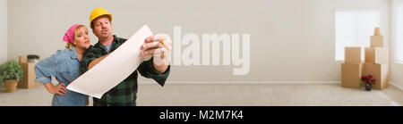 Contractor in Hard Hat Discussing Plans with Woman in Empty Room with Moving Boxes Banner. Stock Photo