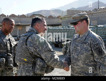 091224-A-3421S-097: NANGARHAR PROVINCE, Afghanistan (Dec. 24, 2009) – U.S. Army Sgt. Adam W. Pledger, Troop A, 1st Squadron, 108th Cavalry Regiment, and a resident of Summerville, Ga., is commended by Maj. Gen. Curtis M. Scaparrotti, the Combined Joint Task Force 82nd commanding general, and Command Sgt. Maj. Thomas R. Capel, during a surprise visit to the over watch of what Scaparotti designates a security priority.  Pledger and four other Soldiers serving in the vital Kyber Pass border crossing were presented the general’s coin for excellence.   (U.S. Army Photo by Sgt. Tracy J. Smith, 48th  Stock Photo