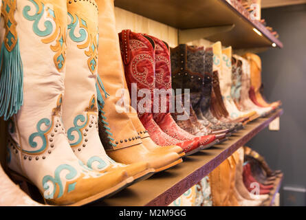 Cowboys boots on a shelf in a store, aligned Stock Photo