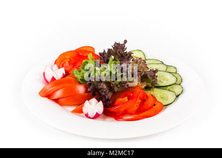 Sliced vegetables on a plate. Isolated on a white background. Stock Photo