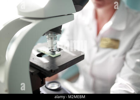 close up of scientist with microscope, examining samples Stock Photo