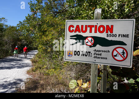 Alligator warning sign on a walking path, J. N. Ding Darling National Wildlife Refuge, Sanibel Island, Florida Stock Photo