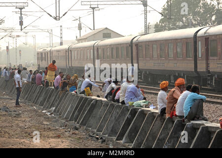 Indian rail passengers waiting on the tracks for a train to arrive, Rajasthan,India Stock Photo