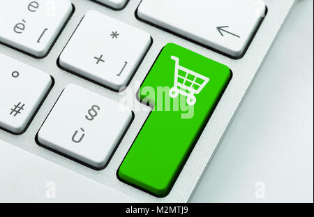 Computer notebook keyboard with icon shopping cart on key. E-commerce concept Stock Photo