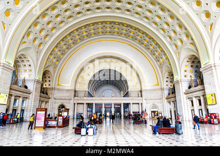 Washington DC, USA - October 27, 2017: Inside Union Station in capital city with transportation signs and people walking, waiting, sitting on benches 