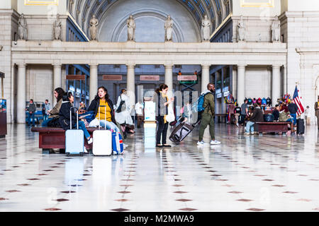 Washington DC, USA - October 27, 2017: Inside Union Station in capital city with transportation signs and people walking, waiting, sitting on benches  Stock Photo