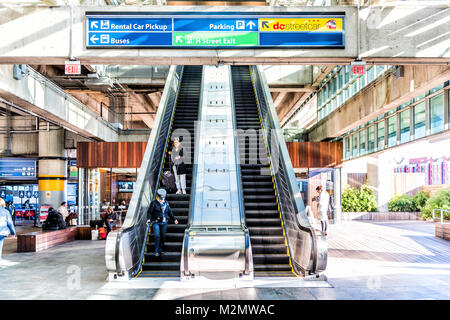 Washington DC, USA - October 27, 2017: Inside Union Station escalator to garage parking for buses in capital city with people walking by direction sig Stock Photo