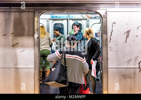 New York City, USA - October 28, 2017: People in underground platform transit in NYC Subway Station on commute with train, people crammed crowd with o Stock Photo