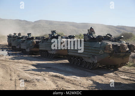 U.S. Marines with Kilo Company, 3rd Assault Amphibian Battalion, Battalion Landing Team, 3rd Battalion, 1st Marine Regiment prepare to move toward a notional military objective on Camp Pendleton, California, Jan. 31, 2018. During the two-week raids course, both mechanized and air assault raid forces will conduct simultaneous training to refine their tactics, techniques, and procedures. (U.S. Marine Corps photo by Cpl. Danny Gonzalez) Stock Photo