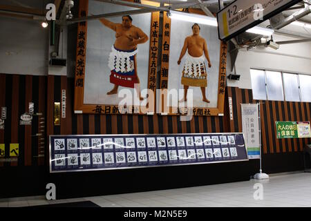 Pictures of Japanese sumo wrestlers at Ryogoku Station, Musashimaru Koyo (left) and Hakuho Sho (right). Below are sumo hand prints. (May 2017) Stock Photo