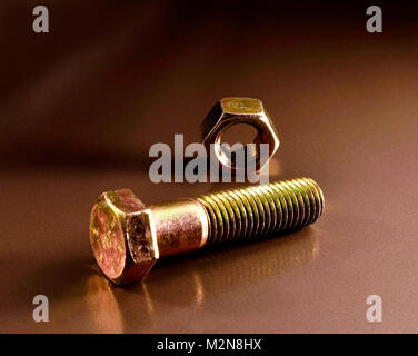 a nut and bolt on a clean surface Stock Photo