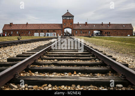 OSWIECIM, POLAND - JANUARY 27, 2016: The Gate of Death of the former German Nazi concentration and extermination camp Auschwitz Birkenau II . Stock Photo