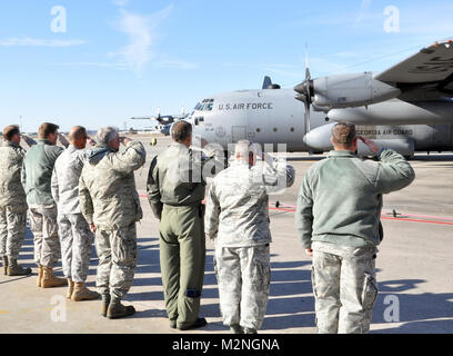 COMBAT READINESS TRAINING CENTER, Garden City, Ga., Jan. 7, 2011 - Members of Savannah's 165th Airlift Wing line the flight ramp and salute 'Chalk Six,' last of six 165th C-130H2s to leave Georgia on a three-month deployment to Bagram Air Base, Afghanistan. It carries with it the remainder of more than 150 flight, maintenance and operations personnel who will work for the Air Force's 7744th Air Expeditioniary Wing. The first five aircraft left for Southwest Asia on New Years Eve. (Georgia Department of Defense photo by Staff Sgt. Matthew Rice) 165th Airlift Wing deploys for ninth time since 9  Stock Photo