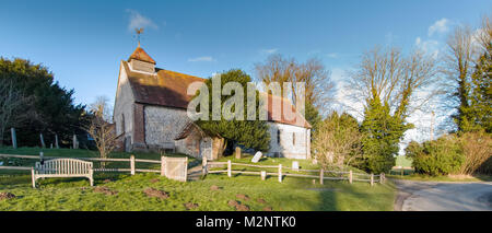 St Peters Church and thatched village well. East Marden, West Sussex, UK Stock Photo