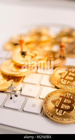 Bitcoin with little figure on keyboard Stock Photo - Alamy