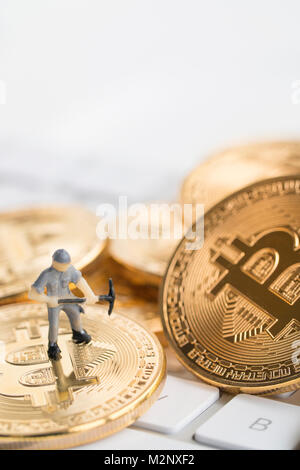 Bitcoin with little figure on keyboard Stock Photo - Alamy