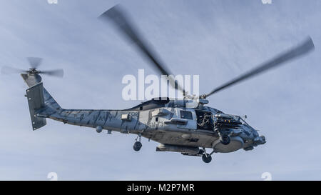 180206-N-MJ135-1158 ARABIAN GULF (Feb. 6, 2018) An MH-60R Sea Hawk, assigned to the Battlecats of Helicopter Maritime Strike Squadron (HSM) 73, takes off from the flight deck of the aircraft carrier USS Theodore Roosevelt (CVN 71). Theodore Roosevelt and its carrier strike group are deployed to the U.S. 5th Fleet area of operations in support of maritime security operations to reassure allies and partners and preserve the freedom of navigation and the free flow of commerce in the region. (U.S. Navy photo by Mass Communication Specialist 3rd Class Spencer Roberts/Released) Stock Photo