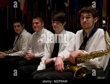 110313-N-5508A-008 Bangor, Me  (March 21, 2011) Four lucky students at Bangor High School prepare to join the Navy Band on stage for a performance of Sousa's 'Washington Post March'. The Navy band is currently on a 22 day tour of the Northeast US. The U.S. Navy Band in Washington, D.C. is the Navy's premier musical organization and performs public concerts and military ceremonies in the greater Washington area and beyond. (U.S. Navy photo by Musician 1st Class David B. Aspinwall/Released) 110321-N-5508A-008 by United States Navy Band Stock Photo